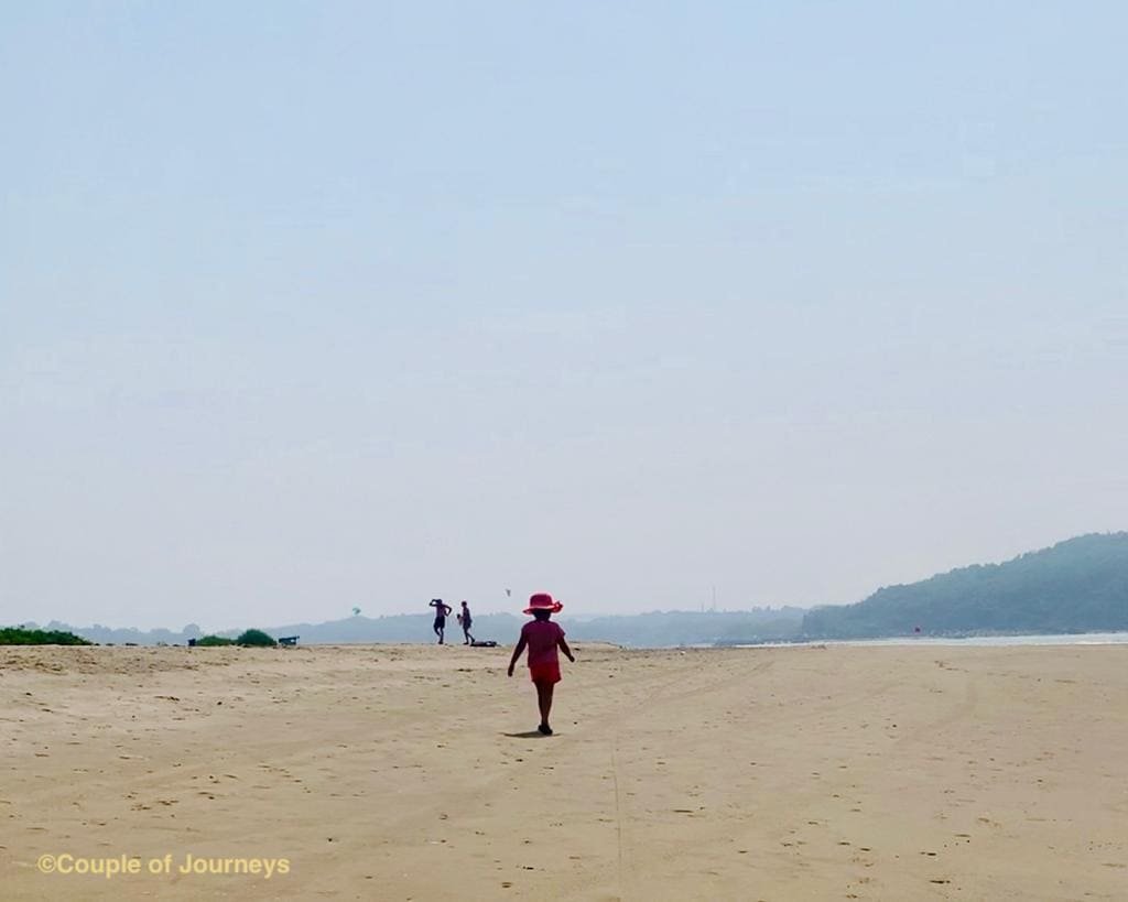 Baby girl walking at Morjim beach
