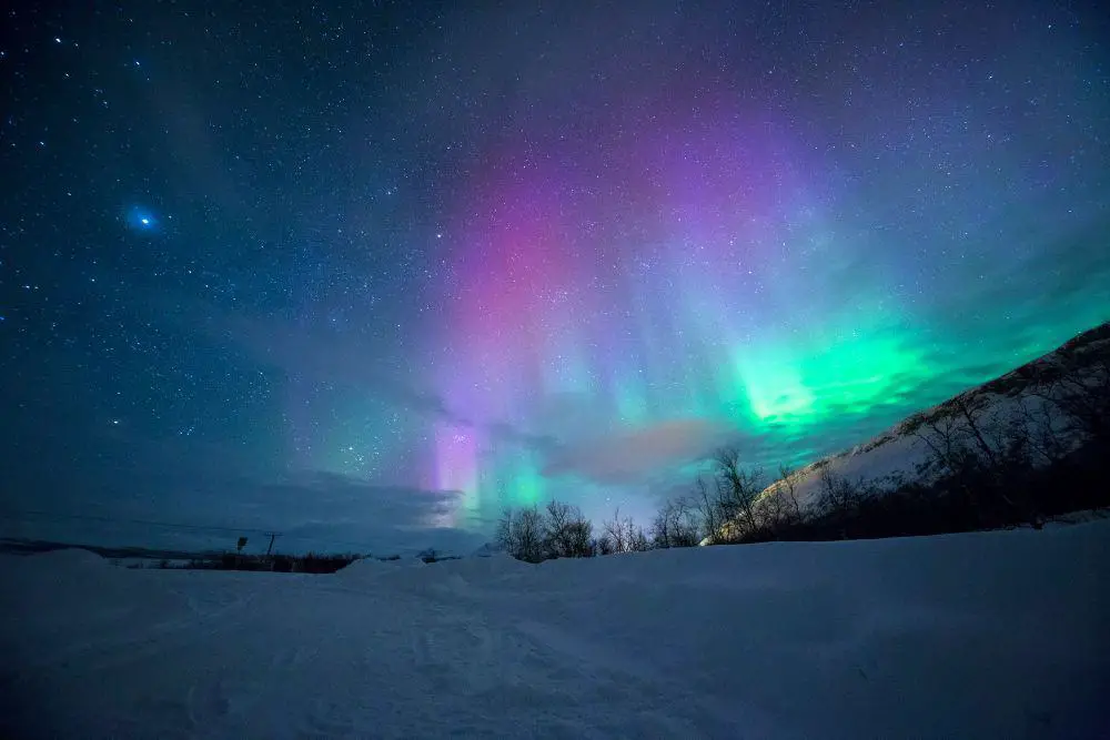 Visit Lapland to witness the mesmerizing Northern Lights and enjoy a cozy winter honeymoon.