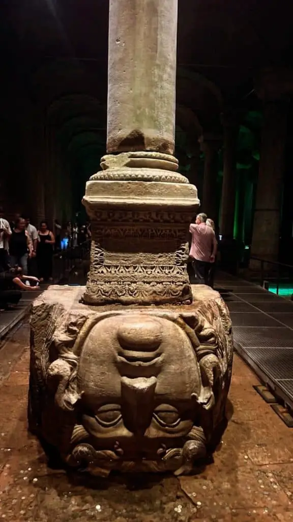 A close-up of the Medusa head column base at the Basilica Cistern in Istanbul, with dim lighting creating a mysterious and historical atmosphere, featured in an Istanbul Instagram story.