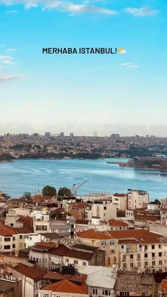  A serene view of Istanbul's rooftops leading to the Bosphorus, under a clear blue sky with the caption "MERHABA ISTANBUL!