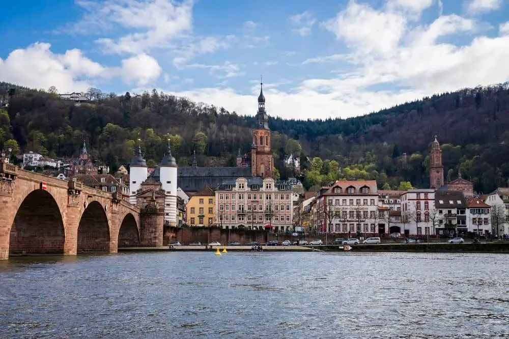 A romantic view of Heidelberg’s Old Bridge and castle, with charming riverside houses along the Neckar River—one of the most iconic honeymoon destinations in Germany for history-loving couples