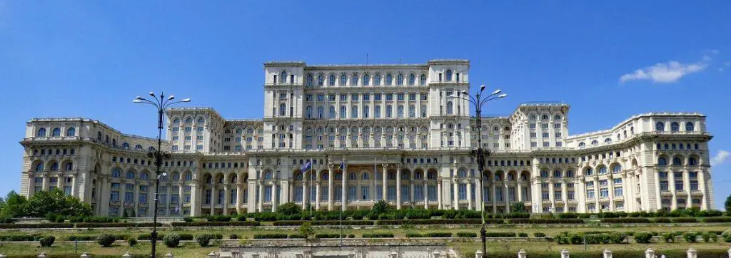 The grand Palace of Parliament under a clear blue sky, highlighting why Romania is an affordable gem for Cheap Travel Destinations in Europe Summer.