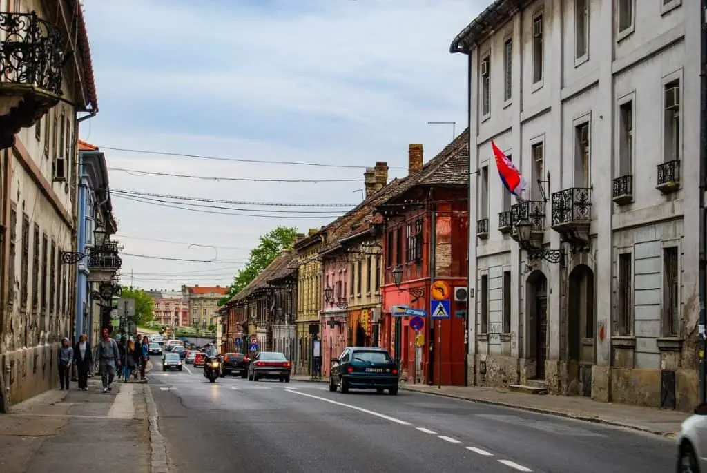  A picturesque street in Novi Sad with colorful buildings and local charm, making it a must-visit for Cheap Travel Destinations in Europe Summer.