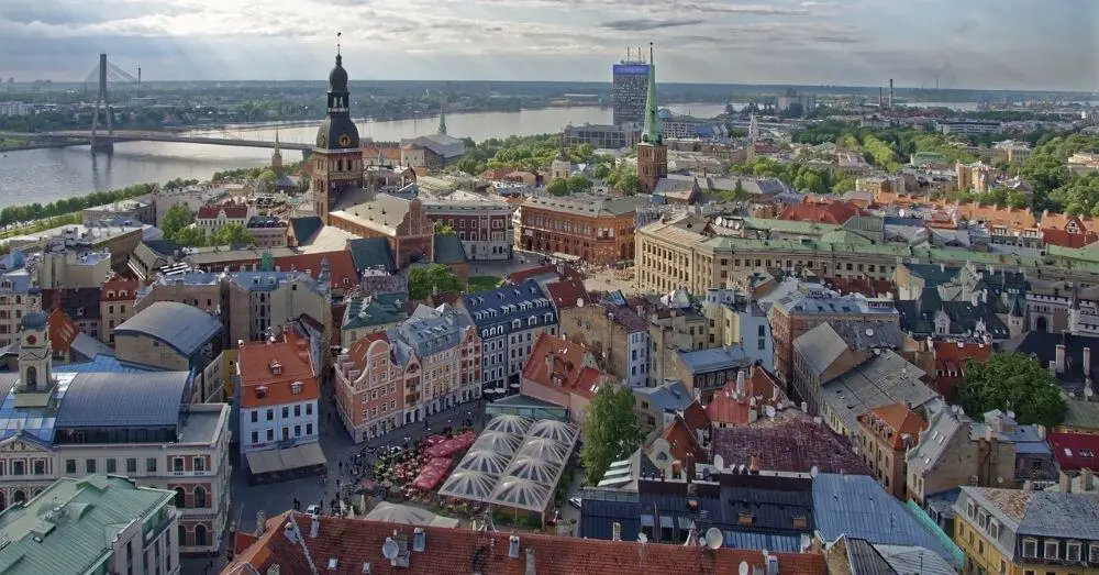 A breathtaking aerial view of the Old Town with colorful buildings and the Daugava River, making it a must-visit for Cheap Travel Destinations in Europe Summer