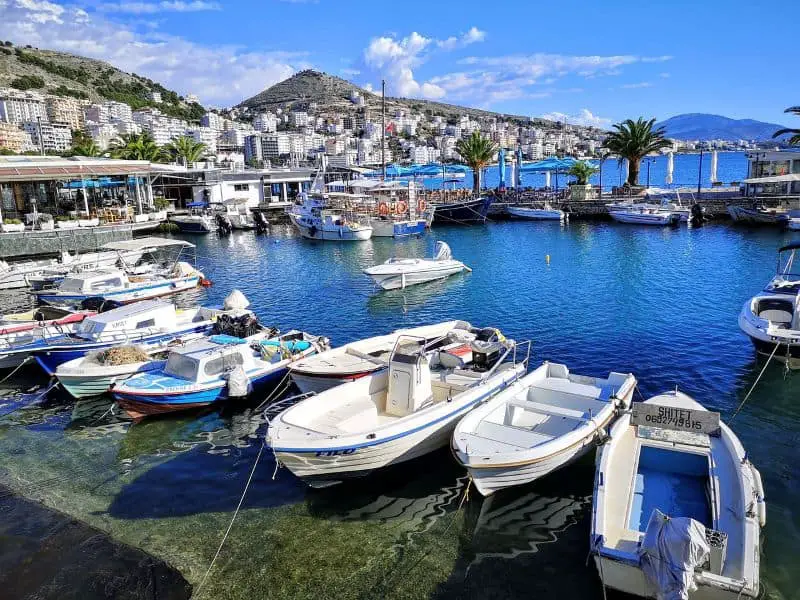 A picturesque marina with boats docked along the turquoise waters, perfect for travelers seeking Cheap Travel Destinations in Europe Summer